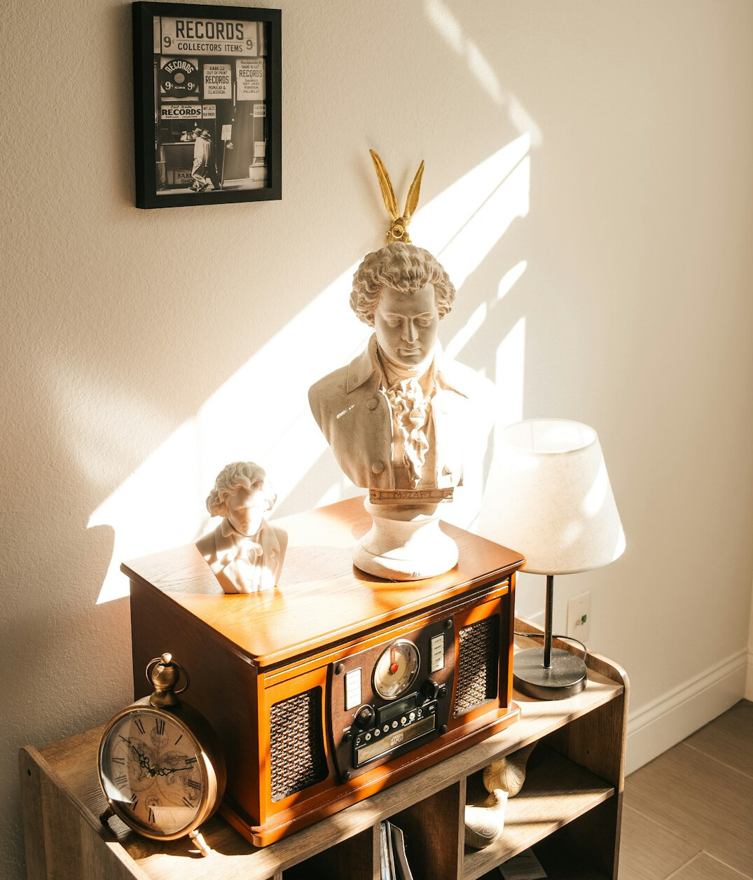 Stack of vintage interior design magazines and a film camera on a wooden desk